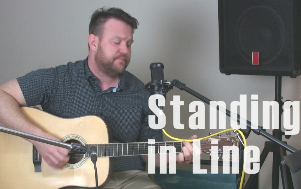 miles playing acoustic guitar and singing