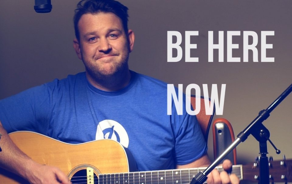 Guy playing acoustic guitar